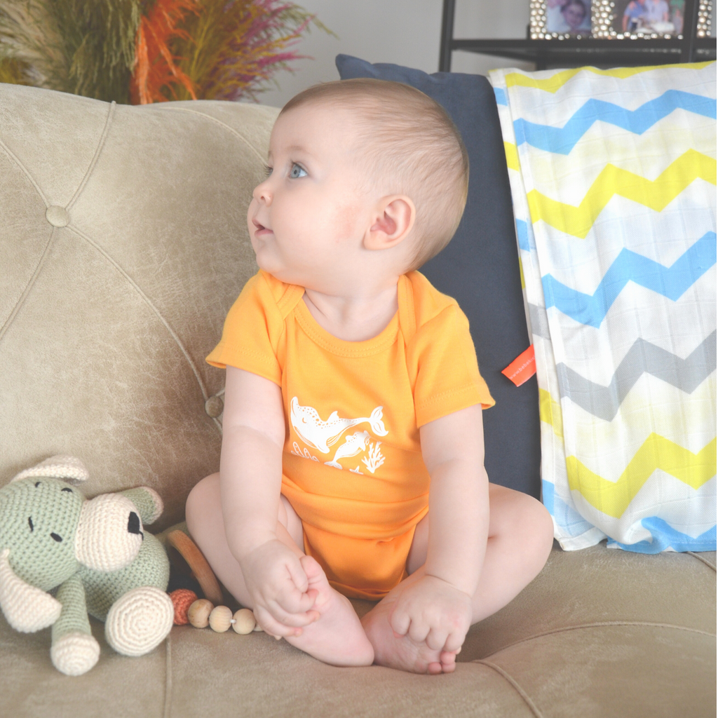 a baby is sitting with Bebekish Short Sleeve Bodysuit